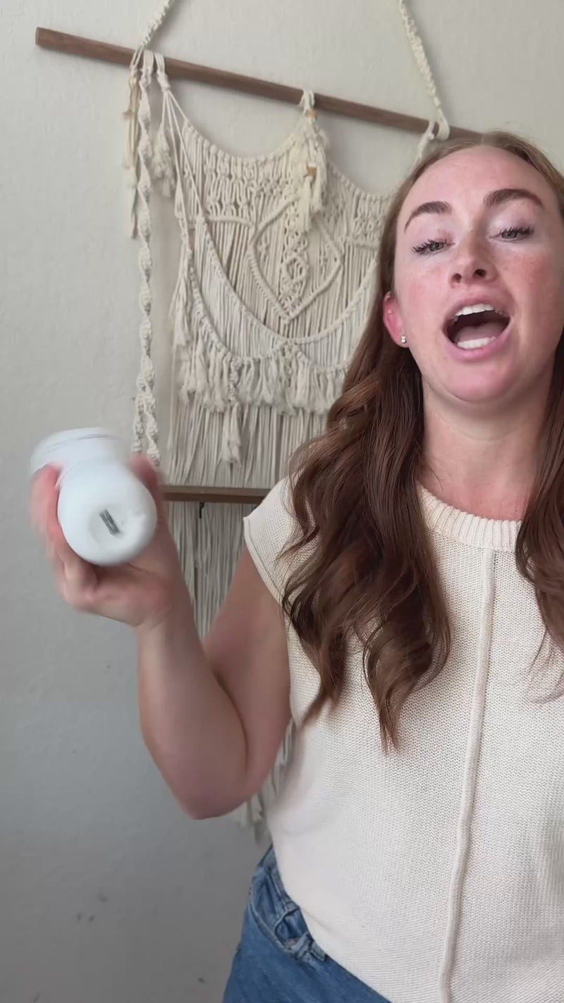 Woman holding a bottle in a Blyss website video